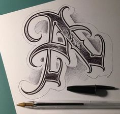 a drawing of the letter d with some ink on paper and a pen next to it