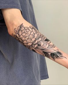 a person with a flower tattoo on their arm