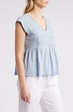 Floral embroidery rendered in tonal threads brings nearly 3D texture to the bib of this babydoll-style top cut from fresh, lightweight cotton. 22" length (size Medium) V-neck Cap sleeves 100% cotton Machine wash, tumble dry Imported Short Sleeve Tops With Tonal Embroidery For Spring, Spring Tops With Tonal Embroidery And Short Sleeves, Light Blue Short Sleeve Top With Floral Embroidery, Spring Cotton Top With Broderie Anglaise, Spring Cotton Top With Broderie Anglaise Embroidery, Spring Cotton Embroidered Top With Broderie Anglaise, Spring Broderie Anglaise Cotton Embroidered Top, Tonal Embroidery Short Sleeve Tops, Casual Cotton Embroidered Top With Broderie Anglaise