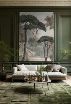 a living room with green walls and paintings on the wall, couches and tables