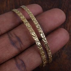 This is a set of two very thin hammered 14k gold filled bangles. They are hammered into an elegant circle, and then double hammered in the center to give them a rustic forged look. Each is finished with a simple hook closure. These are dainty and versatile, the perfect set of bangles for a small touch of gold adornment. I like to wear one on each wrist, they are so subtle and feminine:) How do you measure bangle size at home? CRITERIA TO MEASURE BANGLE SIZE Cut a thin thread. Bring your thumb an Gold Bangle Indian, Bracelet Women Gold, Bracelet Bangle Gold, Gold Bracelet Bangle, Indian Bracelets, Bangle Stacking, Gold Bangles Indian, Dope Jewelry Accessories, Indian Bangles