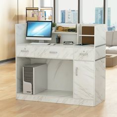 a white desk with a computer on top of it