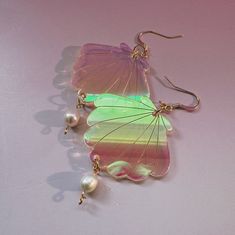 Irridescent acrylic sea shells with real pearl accents will add a touch of whimsy to any outfit. With a 2-1/2" drop length, these earrings are perfect for all my sirens out there. Every piece of jewelry is hand formed and hand assembled by me. Due the unique nature of the product you may not get the pictured earrings. Whimsical Iridescent Earrings With Ear Wire, Iridescent Dangle Earrings With Abalone Shell, Iridescent Abalone Shell Dangle Earrings, Iridescent Dangle Earrings From Abalone Shell, Handmade Iridescent Mother Of Pearl Earrings, Moon Water, Black Glaze, Black Stud, Unique Nature