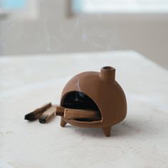 This Stoneware Footed Incense Chimney in a reactive glaze terra-cotta color is a functional piece of art. Each one will vary, adding to the uniqueness of the item. The round, robust body and footed design make it a stable and attractive addition to any room. Whether placed in a Boho-styled lounge, a modern office, or a rustic kitchen, it carries the essence of craftsmanship and style. Its size is perfect for personal use or as a thoughtful gift for those who appreciate the bohemian and earthy ae Incense Chimney, Unique Ceramic Ideas, Ceramic Glaze Ideas, Pottery Gift Ideas, Clay Incense Burner, Clay Incense, Paint Pottery, Making Pottery, Aesthetic Objects