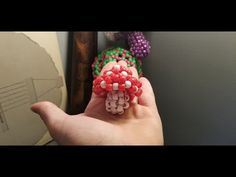 someone is holding some beads in their hand