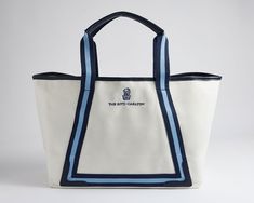 The Ritz-Carlton Tote easily transitions from the beach to sightseeing to shopping excursions. This chic 100% cotton canvas tote with faux leather details sports The Ritz-Carlton logo and has ample space to fit your beach towel and other on-the-go accessories. Summer Shopping Bags With Embroidered Logo, Sporty Cotton Canvas Travel Bag, Cotton Beach Bag With Canvas Lining For Travel, Sporty Canvas Tote Bag, Casual White Beach Bag With Canvas Lining, Travel Cotton Bag With Embroidered Logo, Casual Canvas Travel Bag With Embroidered Logo, Rectangular Travel Canvas Bag With Embroidered Logo, Travel Bag With Embroidered Logo In Cotton