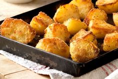 a pan filled with tater tots sitting on top of a table