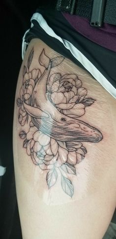 a woman's thigh with a bird and flowers on it