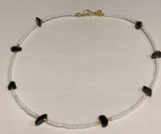 Beautiful beaded necklace containing pretty black onyx gemstone chips and white and gold glass seed beads Gold plated fastenings Other gemstones available, please check out my other listings or drop me a message and I can make up in your desired stone As this contains natural gemstones - they may vary slightly in colour, shape, design and size As this item contains small parts please keep away from small children as it may be a choking hazard To prevent damage please remove before swimming, show Heart Shaped Tiny Beads Jewelry Gift, Heart Shaped Beaded Jewelry Gift, Heart-shaped Tiny Beads Jewelry Gift, Gold Necklaces With Round Heart Beads, Gold Necklaces With Heart-shaped Round Beads, Gold Necklace With Heart And Round Beads, Polished Beads Choker Necklace For Gifts, Heart Beaded Necklaces As Gifts, Heart And Round Beads Necklace For Gift