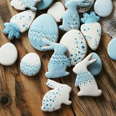 blue and white decorated cookies sitting on top of a wooden table