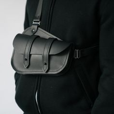 Black Leather Belt Bag With Gunmetal Hardware, Classic Black Saddle Bag With Gunmetal Hardware, Classic Leather Strap Crossbody Saddle Bag, Leather Saddle Bag With Belt Loops, Crossbody, Leather Crossbody Saddle Bag With Belt Loops, Classic Black Shoulder Bag For Everyday, Black Leather Saddle Shoulder Bag, Black Shoulder Bag With Leather Backing For Everyday Carry, Over The Shoulder Carry