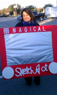 a woman holding up a sign that says sketch at