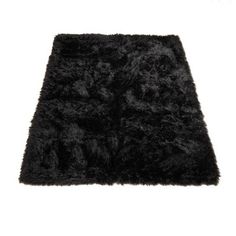 a black shaggy rug is shown on a white background and it looks like an area rug