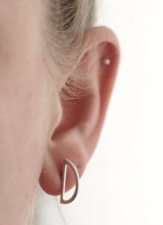 "I formed these half circle earrings out of sterling silver. I love the way they sit perpendicular against your earlobe. They are very lightweight and comfortable. Perfect to pair with other studs along your ear. I gave them a matte finish. Earrings measure 5/8\" x 3/8\". CURRENT LEAD TIME ON ALL ORDERS: 2 Weeks SHIP TIME TO US: 2-7 business days SHIP TIME OUTSIDE US: Up to 8 weeks (although typically around 1-3 weeks)" Modern Nickel-free Ear Cuff As Gift, Modern Nickel-free Cartilage Earrings For Everyday, Modern Nickel Free Cartilage Earrings For Everyday, Modern Nickel-free Everyday Cartilage Earrings, Modern Sterling Silver Single Cartilage Earring, Semi-circle Sterling Silver Earrings Gift, Modern Teardrop Sterling Silver Wrap Earrings, Modern Semi-circle Earrings For Everyday Wear, Modern Sterling Silver Teardrop Wrap Earrings