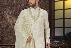 This is a premium sherwani Indo Western  by Groom Wear Studio crafted from high quality fabric and imported materials. Our products are handcrafted by experienced tailors who make sure the that the stitching is precise, lining is proper and the overall product is sturdy enough to not go out of shape for more than a few years. Also all our products have extra margins in their length, sleeves, sides so it's easily alterable if your size changes after some time. To see more available colours and de White Sherwani, Groom Sherwani, Sherwani Groom, Sherwani For Men, Ethnic Wedding, Stylish Man, Groom Wear, Out Of Shape, Indo Western