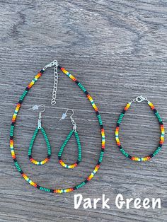 two pieces of beaded jewelry sitting on top of a wooden table