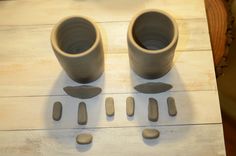 two cups and spoons are sitting on a table