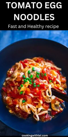 an egg noodle dish on a blue plate with chopsticks in the middle