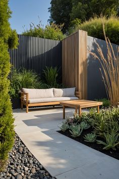 a wooden bench sitting in the middle of a garden next to some plants and trees