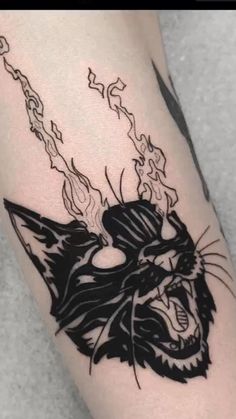 a black and white cat tattoo on the leg