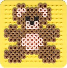 a teddy bear made out of legos sitting on top of a yellow plate with buttons