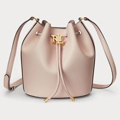 Lauren Ralph Lauren's Andie Small Leather Drawstring Bag Provides Ample Storage For Your Essentials And Features An Oversize "Lrl" Metal Stopper For An Iconic Finish. Small Sized Bag; 8-1/4"W X 11-3/4"H X 5-3/4"D (With Is Measured Across The Bottom Of Handbag); 0.92 Ibs. Approx. Weight Silhouette Is Based Off 5'9" Model 20"L Adjustable Strap Drawstring Closure With Polished "Lrl" Metal Stopper & Magnetic Snap Closure Gold-Tone Hardware Interior Slip Pocket Dust Bag Included Leather; Lining: Polyester Professional Leather Clean Dust Bag Included. Luxury Pink Bucket Bag For Travel, Luxury Pink Bucket Bag, Classic Pink Bag With Dust Bag Included, Designer Pink Bucket Bag For Travel, Luxury Pink Shoulder Bucket Bag, Luxury Pink Bucket Bag For Everyday, Luxury Pink Bucket Bag For Shopping, Luxury Pink Bucket Bag With Removable Pouch, Pink Formal Pouch Bag