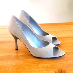 These Elegant Open Toe Matte Silver-Gray Satin Pumps Are Lovely For Any Outfit, Even A Wedding Dress! 3.5" Heel. Genuine Leather Soles And Leather Interior. Never Worn, Just Have Light Markings On The Soles From Trying On On My Wood Floors; There Is Some Glitter On The Bottoms Though :), And An Almost Imperceptible Mark On The Right Toe (See Photo) But Are Otherwise In Pristine Condition. Silver Closed Toe Heels For Wedding Guest, Chic Silver Open Toe Wedding Shoes, Chic Silver Wedding Shoes For Spring, Chic Silver Wedding Shoes, Silver Round Toe Shoes For Wedding Guest, Classic Silver Fitted Heels, Classic Fitted Silver Heels, Silver Wedding Shoes With 4-inch Heel For Spring, Fitted Silver Wedding Shoes With 4-inch Heel