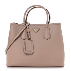 This is an authentic PRADA Saffiano Cuir Medium Double Bag in Cammeo Black. This tote is crafted of Saffiano crossgrain leather in beige-pink. The bag features an optional adjustable shoulder strap, rolled leather top handles, and expandable snap sides. The top is open to a partitioned black leather interior with a central flap pocket. Prada Saffiano, Leather Interior, Leather Top, Flap Pocket, Prada, Shoulder Strap, Black Leather, Handles, Leather