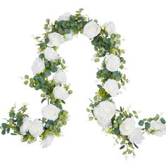 white flowers and greenery are arranged in the shape of an o