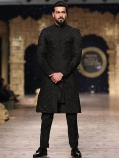 <p><strong>Sherwani:</strong><br />Color: Black<br />Fabric: Polyester Cotton (PC)<br />Elegant sherwani features rich quality embellishments accent the collar, sleeves, front and all over<br />Hidden front hooks closure</p> <p><strong>Inner:</strong><br />Complement with matching kurta and pajama</p> <p><br /><br /><strong>Additional Accessories:</strong> <br /><strong& Long Sleeve Kurta With Naqshi For Reception, Designer Long Sleeve Kurta, Long Sleeve Kurta With Dabka For Reception, Designer Kurta With Resham Embroidery For Designer Wear, Designer Festive Churidar With Resham Embroidery, Unstitched Sherwani For Reception, Designer Unstitched Bandhgala For Designer Wear, Designer Unstitched Kurta With Resham Embroidery, Designer Kurta For Reception And Transitional Seasons