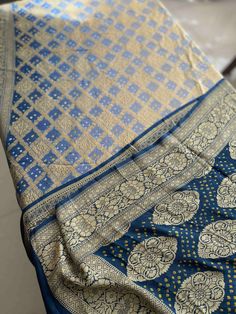 A Handmade Navy Blue & Cool Grey shaded Pure Khaddi Georgette Bandhani/ Bandhej Saree woven in pure Meenakari Zari- an invitation for a true self-indulgence. The fall and pico are done for this saree. It comes along with a Navy Blue Bandhani Blouse piece that also has a meenakari zari border.   Our Policy on Returns, refunds and exchanges: We don't accept requests for returns and exchanges on the below observations: Non-defects: *Small knots or bumps in the silk threads.  *Uneven threads because Unstitched Blue Bandhani Saree, Blue Bandhani Print Unstitched Saree, Blue Salwar Kameez With Traditional Patterns For Navratri, Blue Semi-stitched Dupatta For Diwali, Semi-stitched Blue Dupatta For Diwali, Traditional Royal Blue Dupatta With Cutdana, Traditional Royal Blue Cutdana Dupatta, Festive Royal Blue Art Silk Dupatta, Blue Art Silk Dupatta With Pallu