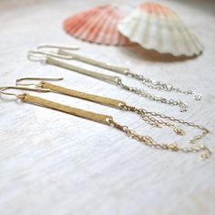 "These alluring vertical bar earrings come in either sterling silver or gold filled. They're made from 14g wire that's been hammered down and has fine cable chains dangling from them. The bars are 1 1/2\" long and longest chain is 1 1/2\". You'll definitely want to get one of each!" Minimalist Hammered Dangle Linear Earrings, Gold Bar Earrings, Glass Drop Earrings, Vertical Bar, Sea Glass Earrings, Bar Earrings, Shell Earrings, Hammered Silver, Glass Earrings