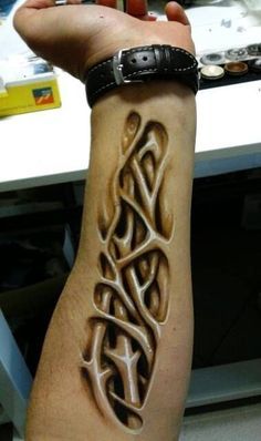 a person with a tattoo on their arm that has an intricate design in the middle