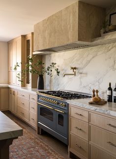 a kitchen with marble counter tops and an oven in the center, surrounded by wooden cabinets