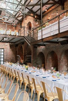 an indoor venue with tables and chairs set up for a formal dinner or party in the center