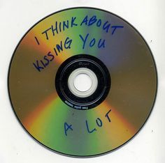 a cd with writing on it that says i think about kissing you at lol