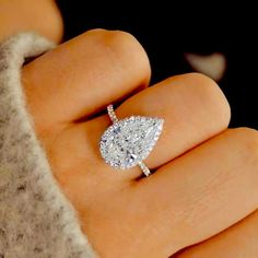 a woman's hand with a diamond ring on it