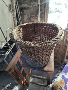 a wicker basket sitting on top of a wooden stand