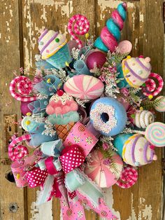 a colorful bouquet with donuts, candy and lollipops on the front door