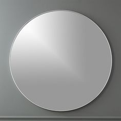 a round mirror mounted to the side of a wall