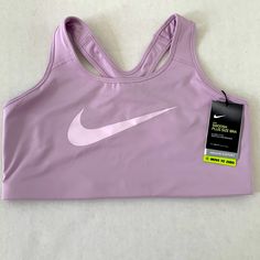 Nike Dri-Fit Swoosh 1x Plus Size Lavender/Light Purple Sports Bra Functional Purple Sports Top, Purple Moisture-wicking Training Tops, Breathable Purple Tops For Sports, Purple Sportswear Training Top, Purple Sportswear Tops For Training, Purple Moisture-wicking Sleeveless Sports Bra, Purple Moisture-wicking Sports Bra, Purple Casual Activewear For Light Sports, Lavender Activewear For Light Exercise