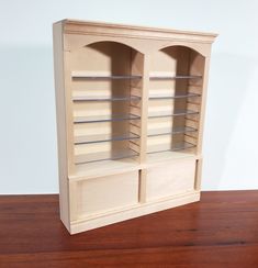 a wooden shelf with two glass shelves on top