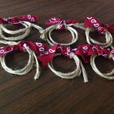 several pieces of rope tied together on a wooden table with red and white numbers painted on them