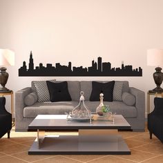 a living room filled with furniture and a large city skyline wall decal