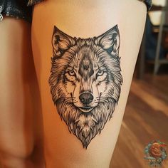 a woman's thigh with a wolf tattoo on it