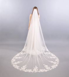 the back of a woman's wedding veil with flowers on it