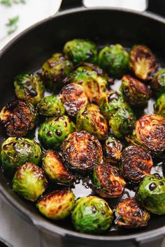 the brussel sprouts are being cooked in a pan on the stove