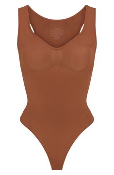 From Kim Kardashian's SKIMS, this curve-hugging bodysuit with a thong back gives support and disappears under clothes. Snap closure Scoop neck Sleeveless 41% recycled nylon, 41% nylon, 18% elastane Machine wash, tumble dry Imported Solid Nylon Bodysuit With Built-in Bra, High Cut Nylon Bodysuit With Built-in Bra, Sculpting Full Coverage Bodysuit With Seamless Construction, Sculpting Full-coverage Seamless Bodysuit, Stretch Nylon Bodysuit With Built-in Bra, Nylon Full Coverage Seamless Bodysuit, Nylon Bodysuit With Built-in Bra And Scoop Neck, Nylon Smoothing Scoop Neck Bodysuit, Nylon Second-skin Bodysuit With Built-in Bra