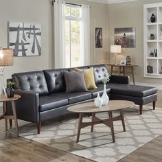 a living room filled with lots of furniture and decor on top of a hard wood floor