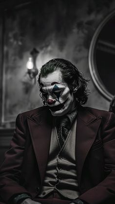 a man dressed as the joker sitting in front of a mirror